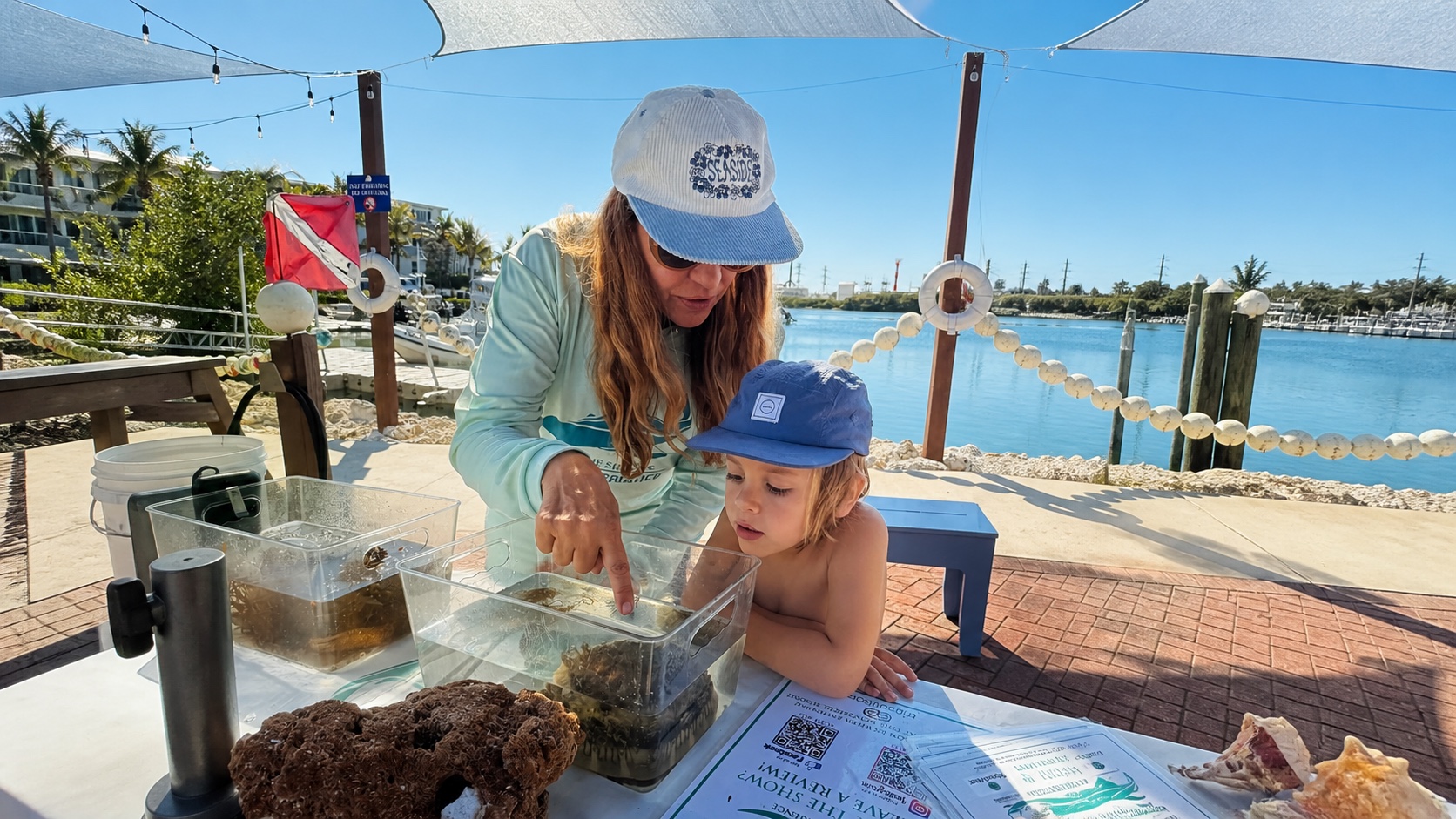 Marine science educator guiding a child through a hands-on touch tank experience